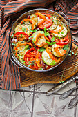 Oven-roasted courgettes with tomatoes and peppers