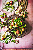 Freshly picked apples in a basket and on plates