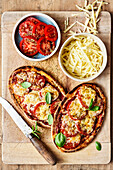 Pitta pizzas with tomatoes and cheese