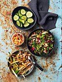 Vegan side dishes: kimchi, pickled cucumber, lettuce, and spring onions (Korea)