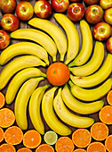 Bananas artistically arranged with mandarins and apples