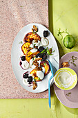 Baked peaches with yoghurt, blackberries and caramelised walnuts