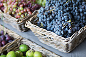 Grapes in baskets on a market stall