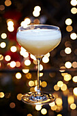 Fruity festive Christmas martini cocktail served in a rounded martini glass