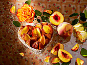 Heart-shaped peach tart with rose petals