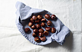 Flat lay with cut chestnuts in a napkin