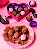 Homemade chocolate truffles in heart shaped gift box
