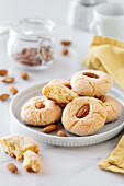 Homemade typical Sardinian amaretti soft biscuits made of almond flour on a plate placed on table