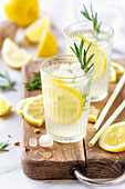 Fresh lemonade with organic lemons, rosemary and ice in a glass
