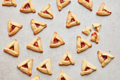 Strawberry Halva Hamantaschen (triangular biscuits with strawberry, tahini, and honey)