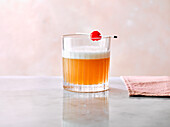 Amaretto Sour with cocktail cherry