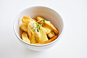 French fries with cheese in a small bowl (Poutine)