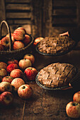 Apple Pie with fresh apples on rustic wooden table