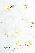Breadcrumbs, basil, and olive oil on a light background