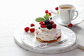Mini cake with whipped cream and fresh fruit raspberries, blackberries, strawberries