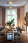 Festively laid Christmas table with cantilever chairs and maple console