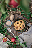 Applesauce donuts on wooden tray outside