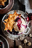Bourbon vanilla ice cream with blueberry compote and pastry stars