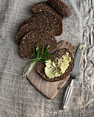 Pumpernickel, one slice spread with butter