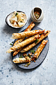Carrot and cherry filo pastry rolls with chimichurri dip and melon salad