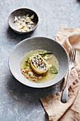Chard and ricotta pasta roll with taleggio in a parmesan broth