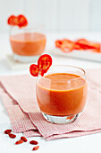 Hearty red smoothie with peppers, red berries and goji