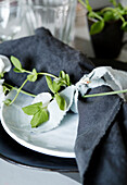 Place setting with pea tendril and tiny mouse figurine