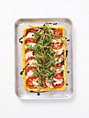 Polenta tart with tomatoes, mozzarella, and rocket salad