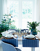 Festively set Christmas table with two blue table runners