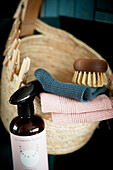 Basket of flannels, brush and clothes pegs and bottle of hand cream