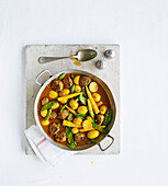Lamb meatball curry with potatoes and snow peas