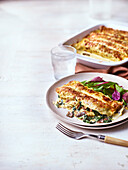 Cheese pancakes au gratin with ham and spinach