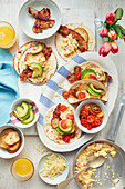 Breakfast tacos with bacon, avocado and tomatoes