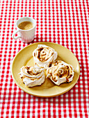 Coffee meringues with plate on red and white checked tablecloth