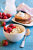 Healthy breakfast: Porridge with berries and pancakes
