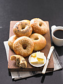 Assorted bagels with butter, served with coffee