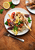 Chicken skewers with grilled vegetables and rice