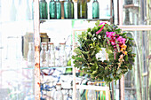 Oak leaf wreath with colorful flowers on vintage shelf