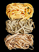 Three different kinds of tagliatelle (uncooked)