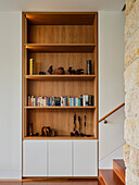 A custom-made bookcase in a wall niche in a living room