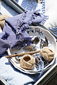 Maritime decor with napkin rings, driftwood and mussel shells on blue and white crockery