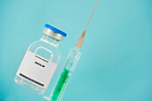 Insulin syringe and vial, conceptual image