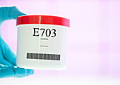 Container of the food additive E703