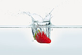 Strawberry splashing in water
