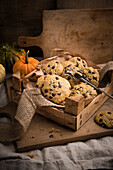 Vegan pumpkin-and-chocolate-chip cookies in a rustic wooden box