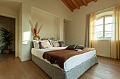 A double bed in a bedroom with cream walls