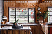 Rustic kitchen made of recycled wood, kitchen island with marble top