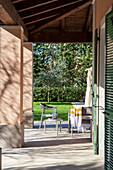 A Mediterranean veranda with a side table and a chair