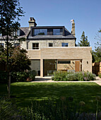 A view from a garden of a Victorian semi-detached house with an extension