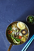 Asian vegetable soup with sushi rice and egg